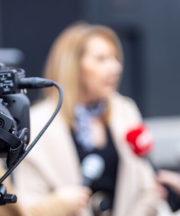 woman-speaking-to-reporters-1423