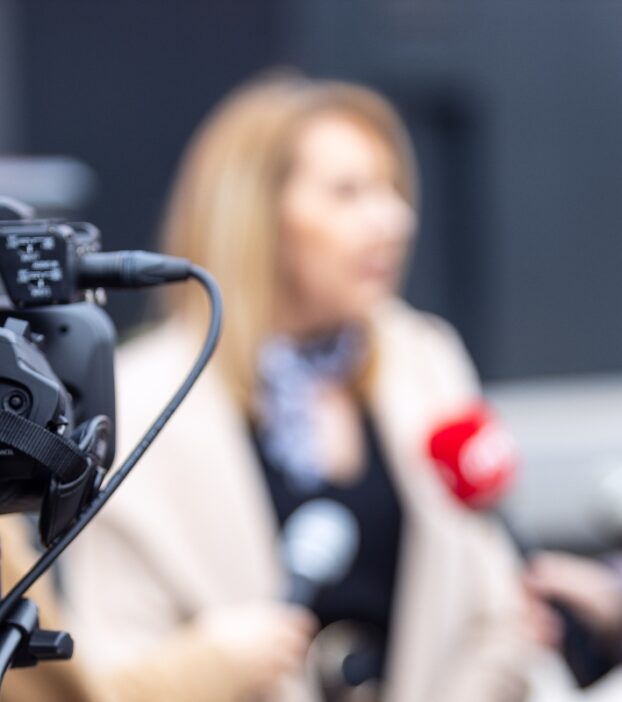 woman-speaking-to-reporters-1423